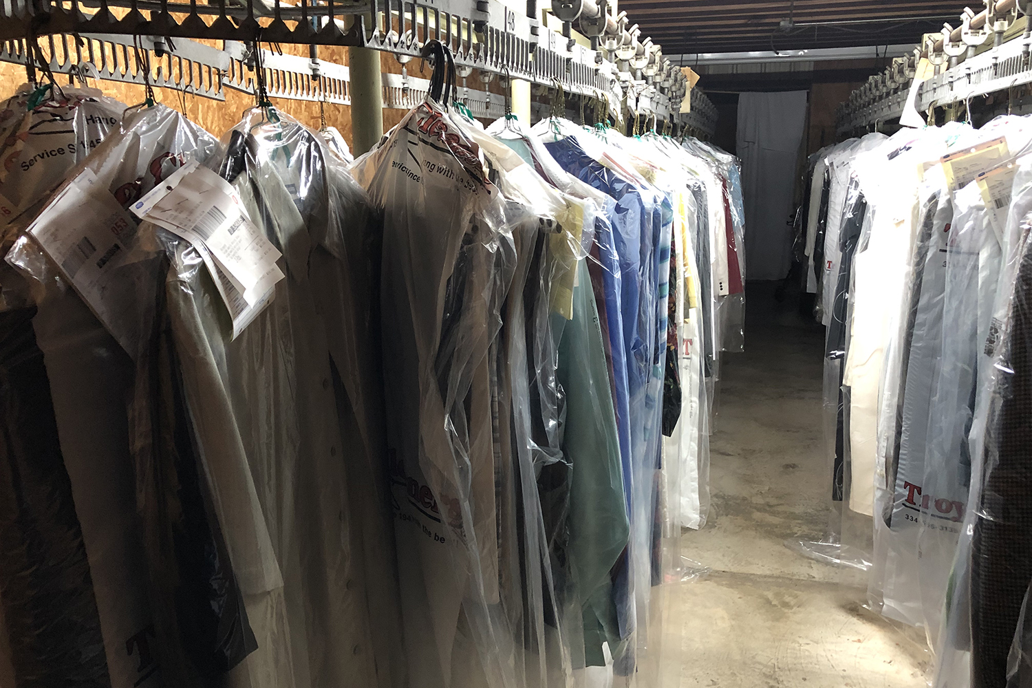 Photo of several articles of clothing that have been cleaned and hung for pickup.